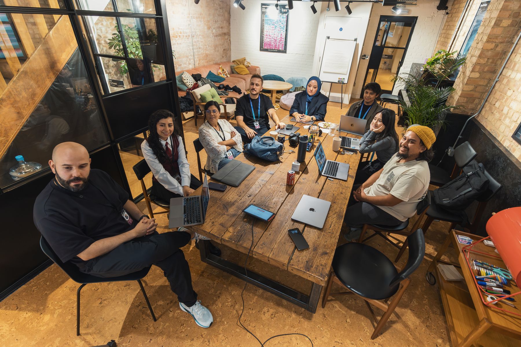A diverse creative team collaborating around a studio table